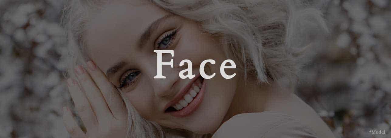 close up headshot of woman smiling with a translucent grey over photo with large white text that says "face"