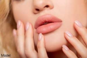 peach color of lipstick on large lips.