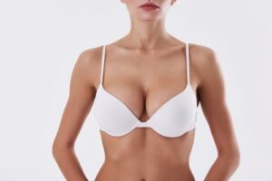 Close up of young woman in white underwear demonstrating her perfect body with silky smooth skin