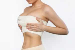 Woman wearing compression bra on breasts after breast augmentation in San Antonio, TX